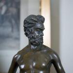 Bronzová socha muže stojícím na rybì V 50 cm